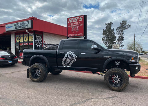 Black lifted Dodge Ram with custom graphics