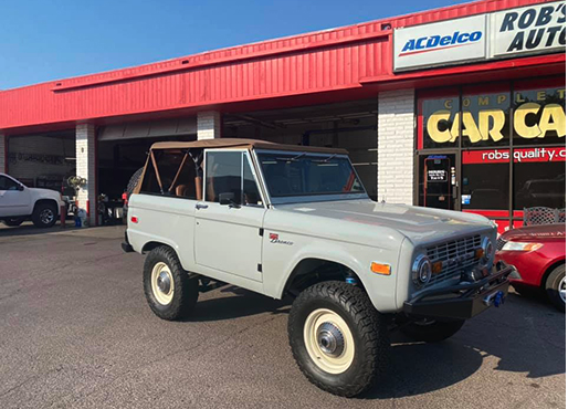 Vintage Ford Bronco with white wheels